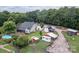 Aerial view of a home with in-ground pool, barns, sheds, trailers and equipment surrounded by trees at 2310 Gill Jordan Rd, Chester, SC 29706