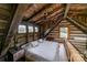 Upstairs bedroom featuring wood walls and ceiling, ceiling fan, and view of wooded area at 2310 Gill Jordan Rd, Chester, SC 29706