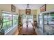 Inviting dining area with large windows offering views of the property and a long wooden table at 2310 Gill Jordan Rd, Chester, SC 29706