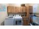 Well-equipped laundry room with washer, dryer, wooden cabinets, and ample storage space at 2310 Gill Jordan Rd, Chester, SC 29706