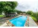 Backyard pool with stone trim, surrounded by greenery and garden beds at 2310 Gill Jordan Rd, Chester, SC 29706