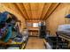 Interior of horse barn with overhead plywood, storage racks, fan, and mini refrigerator at 2310 Gill Jordan Rd, Chester, SC 29706