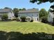 A spacious, well-manicured backyard with lush green grass and a black metal fence at 2567 Holly Oak Ln, Gastonia, NC 28056