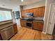 Modern kitchen featuring stainless steel appliances, wooden cabinets, and hardwood flooring at 2567 Holly Oak Ln, Gastonia, NC 28056