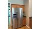 Stainless steel KitchenAid refrigerator with wood cabinets and hardwood flooring at 2567 Holly Oak Ln, Gastonia, NC 28056