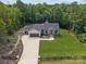 Expansive aerial view of a beautiful home featuring a long driveway, manicured lawn, and surrounded by lush trees at 2577 Bonnybrook Cir, Rock Hill, SC 29732
