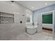 Bathroom featuring tiled wall shower with seat, freestanding tub, and access to the bedroom at 2577 Bonnybrook Cir, Rock Hill, SC 29732