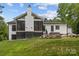 View of the home's screened in porch, hot tub, and patio area in backyard, as seen from the lawn at 2577 Bonnybrook Cir, Rock Hill, SC 29732