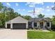 Inviting home featuring a two-car garage, stone accents, covered entryway, and a lush green lawn at 2577 Bonnybrook Cir, Rock Hill, SC 29732