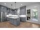 Beautiful kitchen featuring gray cabinets, stainless steel appliances, a center island, and modern pendant lighting at 2577 Bonnybrook Cir, Rock Hill, SC 29732