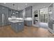Open kitchen featuring a center island, gray cabinetry, stainless appliances, and a seamless transition to the screened-in porch at 2577 Bonnybrook Cir, Rock Hill, SC 29732