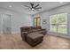 Spacious living room features a comfortable sofa, lots of natural light, and a modern ceiling fan at 2577 Bonnybrook Cir, Rock Hill, SC 29732
