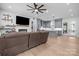 Open-concept living room showcasing hardwood floors, a brick fireplace, and seamless flow into the modern kitchen at 2577 Bonnybrook Cir, Rock Hill, SC 29732