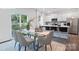 Dining area with a glass table, seating for six, and a view of the modern kitchen at 2617 Goose Fair Rd, Maiden, NC 28650