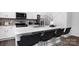 Modern kitchen island with barstool seating, stainless steel appliances, and white cabinetry at 2617 Goose Fair Rd, Maiden, NC 28650