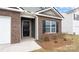 Inviting front entrance with a black door, brick accents, and manicured landscaping at 2650 Goose Fair Rd, Maiden, NC 28650
