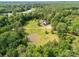 Picturesque aerial view of the property featuring a pond and large, green lawn at 2818 Neill Rd, Lancaster, SC 29720