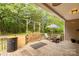 Cozy back porch featuring string lights, outdoor seating, and wooded views at 2818 Neill Rd, Lancaster, SC 29720