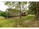 Back of house showing the deck, lush greenery, and peaceful surroundings at 2818 Neill Rd, Lancaster, SC 29720