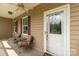 Cozy front porch with seating, decorative windows and door that creates a welcoming entry to the home at 2818 Neill Rd, Lancaster, SC 29720