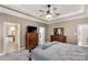 Well-lit main bedroom features a tray ceiling, dresser, and access to bathroom at 2818 Neill Rd, Lancaster, SC 29720