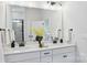 Bathroom featuring double sinks, a large mirror, modern lighting, and sleek black fixtures for a spa-like experience at 3128 Spring Iris Dr, Denver, NC 28037