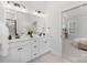 Bright bathroom with double sink vanity and matte black faucet, and view into the main bedroom at 3128 Spring Iris Dr, Denver, NC 28037