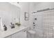 Clean bathroom featuring a white vanity with modern sink and bathtub with a shower at 3128 Spring Iris Dr, Denver, NC 28037
