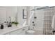 Bright bathroom featuring a white vanity, tub and shower combination, and modern black fixtures at 3128 Spring Iris Dr, Denver, NC 28037