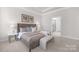 Bright bedroom featuring carpet floors, a tufted headboard, and neutral paint at 3128 Spring Iris Dr, Denver, NC 28037
