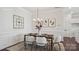 Elegant dining room with wainscoting, stylish lighting, and a sophisticated table setting at 3128 Spring Iris Dr, Denver, NC 28037