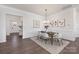 Elegant dining room with hardwood floors, wainscoting, modern chandelier, and neutral color palette at 3128 Spring Iris Dr, Denver, NC 28037
