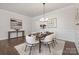 Dining room featuring a modern chandelier, table set for six, and adjacent to the main living area at 3128 Spring Iris Dr, Denver, NC 28037