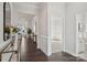 Hallway features hardwood floors, white wainscoting, and access to rooms with carpet and en-suite bath at 3128 Spring Iris Dr, Denver, NC 28037