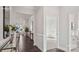 Bright hallway with hardwood floors, wainscoting, and an open view to the living room at 3128 Spring Iris Dr, Denver, NC 28037