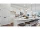 Modern kitchen featuring white cabinets, stainless steel appliances, and a spacious island with seating at 3128 Spring Iris Dr, Denver, NC 28037
