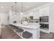 Modern kitchen featuring a spacious island with seating, sleek countertops, and stainless steel appliances at 3128 Spring Iris Dr, Denver, NC 28037