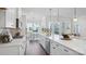 Open kitchen with white cabinetry, stainless steel appliances, and a large island overlooking the living area at 3128 Spring Iris Dr, Denver, NC 28037