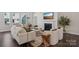 Comfortable living room with a fireplace, stylish furnishings, and large windows for plenty of natural light at 3128 Spring Iris Dr, Denver, NC 28037