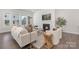 Cozy living room with a fireplace, neutral decor, and large windows providing ample natural light at 3128 Spring Iris Dr, Denver, NC 28037