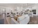 An open concept living room featuring a cozy seating area and a modern kitchen with a large island at 3128 Spring Iris Dr, Denver, NC 28037