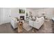Inviting living room featuring a cozy fireplace, stylish seating, and ample natural light at 3128 Spring Iris Dr, Denver, NC 28037