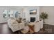 Cozy living room with a fireplace, neutral decor, and large windows providing ample natural light at 3128 Spring Iris Dr, Denver, NC 28037