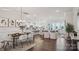 Open concept living space featuring a dining area, kitchen, and comfortable seating area with large windows at 3128 Spring Iris Dr, Denver, NC 28037