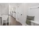 Bright mudroom featuring a bench with coat hooks and a view of the modern kitchen with sleek white cabinets at 3128 Spring Iris Dr, Denver, NC 28037