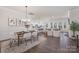 Bright, open concept living space with dining area, kitchen, and living room filled with natural light at 3128 Spring Iris Dr, Denver, NC 28037