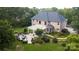 Aerial view of a brick home showcasing the expansive backyard, covered patio, and lush greenery at 3204 Mcpherson St, Waxhaw, NC 28173