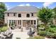 Beautiful backyard showcasing a large brick home with a covered patio and lush landscaping at 3204 Mcpherson St, Waxhaw, NC 28173
