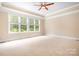 Unfurnished bedroom with beige carpet, crown molding, and many windows at 3204 Mcpherson St, Waxhaw, NC 28173