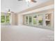 Spacious bonus room with lots of natural light provided by a wall of large windows and neutral carpeting at 3204 Mcpherson St, Waxhaw, NC 28173